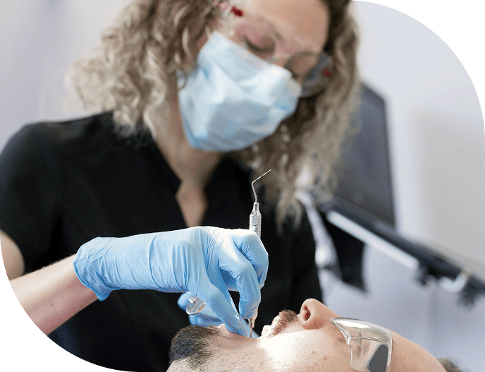 Hygienist cleaning a patient’s teeth.